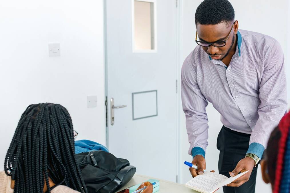 A teacher sharing notes with a student